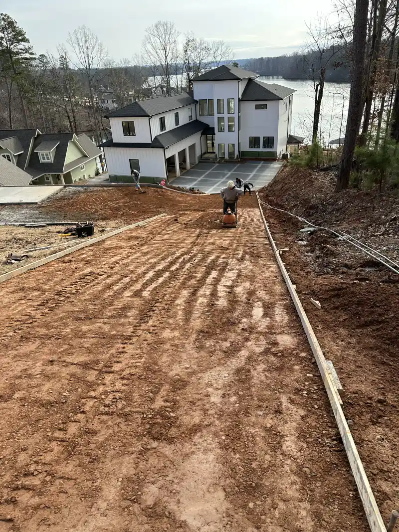 An older concrete driveway showing cracking and surface wear, before replacement.