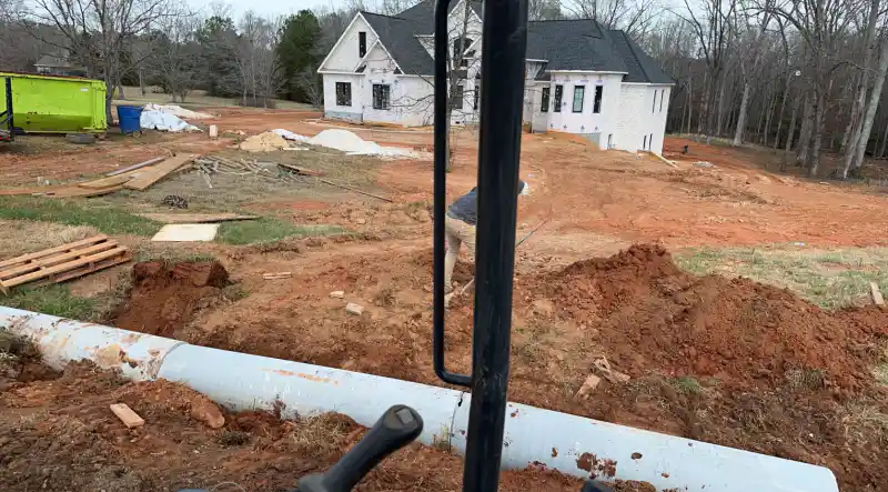 A prepared and compacted subgrade with edge forms set, ready for a driveway pour.
